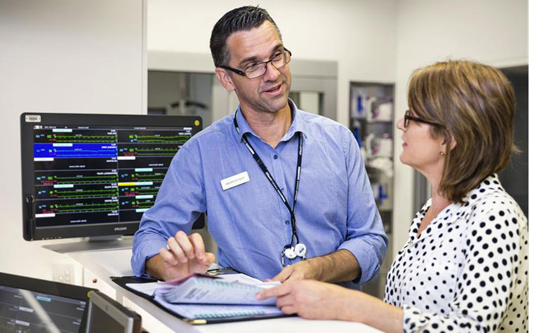 Nurse unit managers discussing patient notes