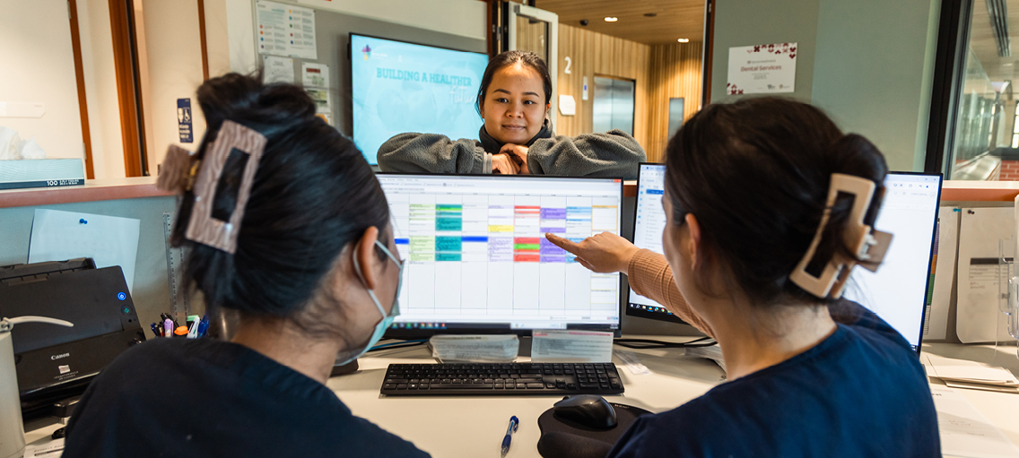Photo of admin staff checking calendar on a computer
