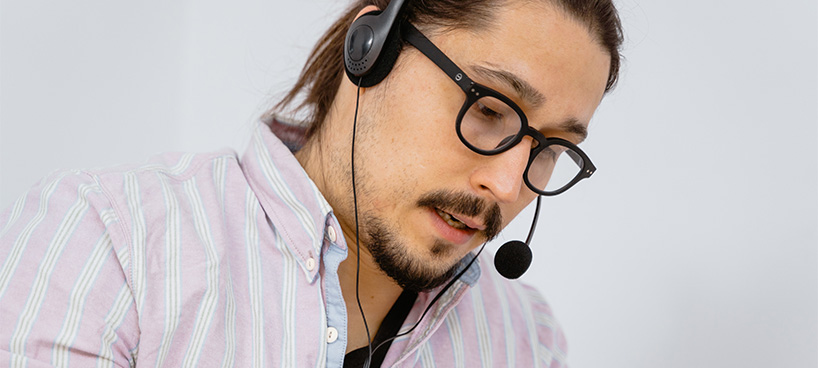 Man talking into telephone headset